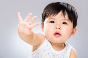 Child uses body language to say stop.